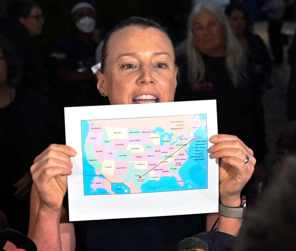 Immigration attorney Rachel Self, standing outside  St. Andrews parish hall in Edgartown Thursday evening, points to the map Venezuelan migrants were shown before being transported to Martha's Vineyard on Wednesday.