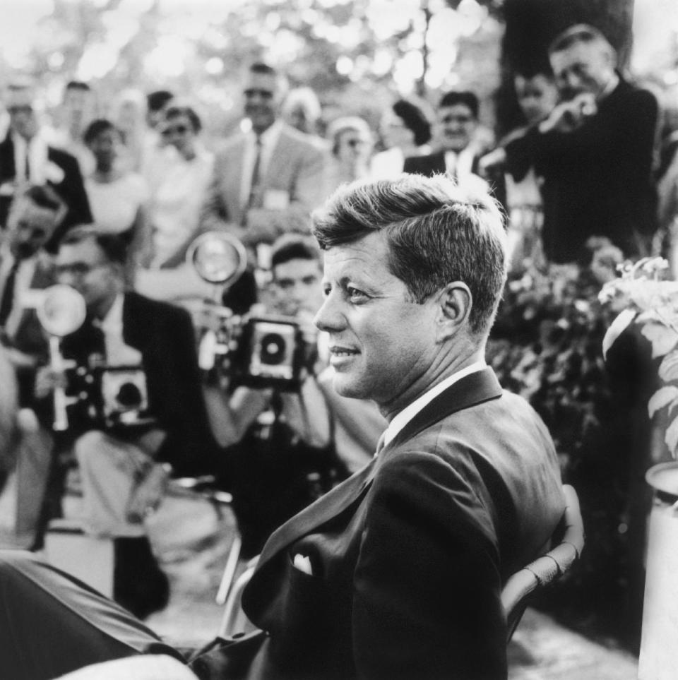 FILE - This handout photo provided by the Newseum, and the estate of Jacques Lowe, shows John F. Kennedy at a news conference in Omaha, Neb. in 1959. Three cities loom large in the life and death of John F. Kennedy: Washington, D.C., where he served as U.S. president and as a senator; Dallas, where he died, and Boston, where he was born. With the 50th anniversary of his Nov. 22, 1963 assassination at hand, all three places are worth visiting to learn more about him or to honor his legacy.(AP Photo/Newseum, estate of Jacques Lowe)