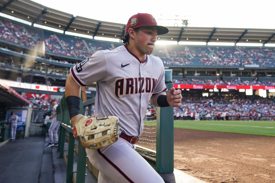 Arizona Diamondbacks left fielder Dominic Fletcher (8) takes the field to warm up before a baseball game against the Los Angeles Angels in Anaheim, Calif., Friday, June 30, 2023. (AP Photo/Ashley Landis)