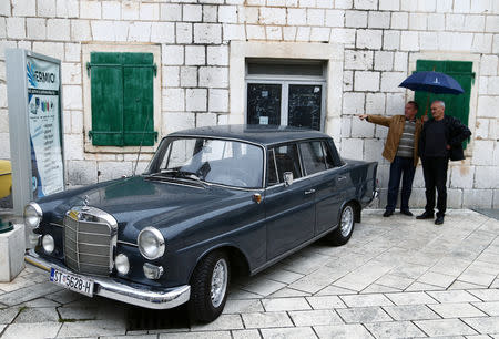 Men look at old-timer Mercedes cars in Imotski, Croatia, May 19, 2019. REUTERS/Antonio Bronic