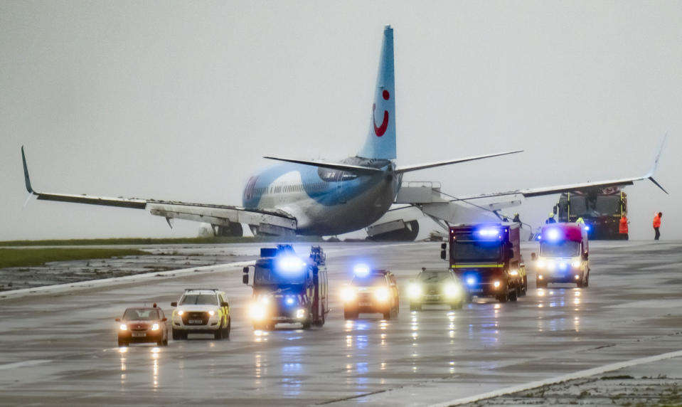 Emergency services at the scene after a passenger plane came off the runway while landing in windy conditions at Leeds Bradford Airport, Leeds, England, Friday, Oct. 20, 2023. (Danny Lawson/PA via AP)