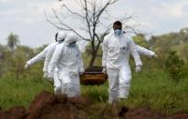 FILE PHOTO: Members of a rescue team carry a body recovered after a tailings dam owned by Brazilian mining company Vale SA collapsed, in Brumadinho