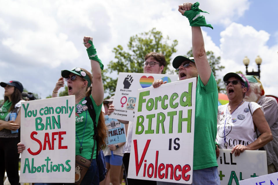 Demonstrators hold signs as they gather for the Women's March in Washington, Saturday, June 24, 2023. Abortion rights and anti-abortion activists held rallies Saturday in Washington and across the country to call attention to the Dobbs v. Jackson Women’s Health Organization ruling on June 24, 2022, which upended the 1973 Roe v. Wade decision. (AP Photo/Stephanie Scarbrough)