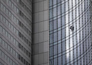 French urban climber Alain Robert, well known as "Spiderman", climbs down the 'Skyper' highrise in Frankfurt, Germany, Saturday, Sept. 28, 2019. (AP Photo/Michael Probst)