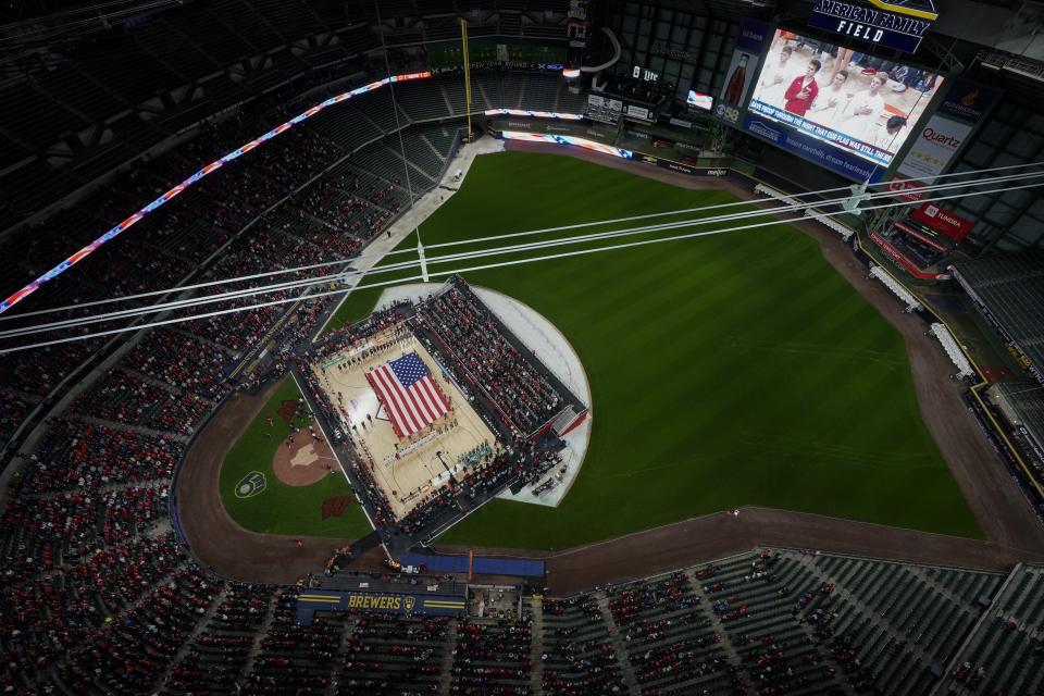 A flag is seen on the court during the national anthem before an NCAA college basketball game between the Wisconsin and the Stanford Friday, Nov. 11, 2022, in Milwaukee. The game is being played at American Family Field, home of the Milwaukee Brewers. (AP Photo/Morry Gash)