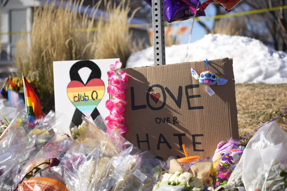 Bouquets of flowers sit on a corner near the site of a mass shooting at a gay bar Monday, Nov. 21, 2022, in Colorado Springs, Colo. Club Q on its Facebook page thanked the "quick reactions of heroic customers that subdued the gunman and ended this hate attack.” (AP Photo/David Zalubowski)