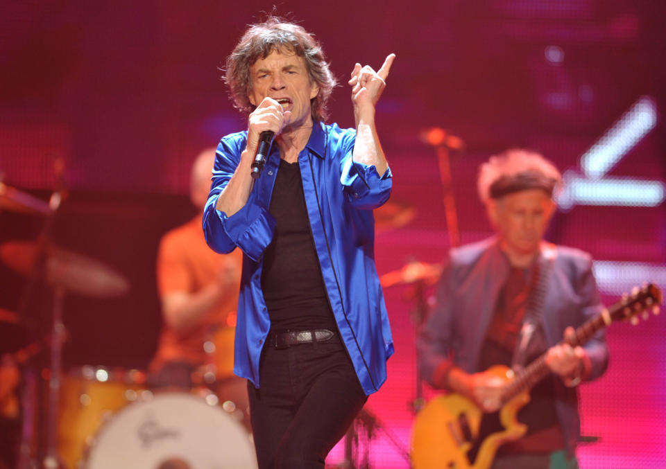 FILE - This May 18, 2013 file photo shows Mick Jagger, center, and Keith Richards, of the Rolling Stones performing on the "50 & Counting" tour at the Honda Center in Anaheim, Calif. Rolling Stones memorabilia will be displayed in a new exhibit, "Rolling Stones 50 Years of Satisfaction," at the Rock and Roll Hall of Fame in Cleveland. The exhibit opens on Friday, May 24. (Photo by John Shearer/Invision/AP, file)