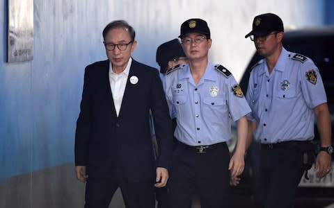 Former South Korean president Lee Myung-bak arrives at court in September to attend earlier hearing into corruption trial  - Credit: AFP