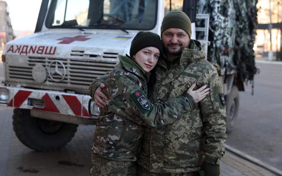 Ivan Synchina, 48, (R) and his daughter Marta Synchina, 25, pose for a picture in Druzhkivka, eastern Ukraine - ANATOLII STEPANOV/AFP