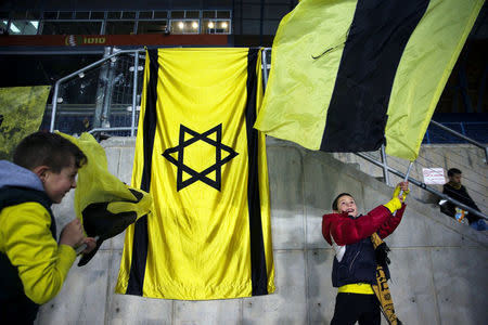 Children supporting Betar Nordia Jerusalem wave flags in the stands during a match at Teddy Stadium in Jerusalem, January 29, 2018. REUTERS/Ronen Zvulun