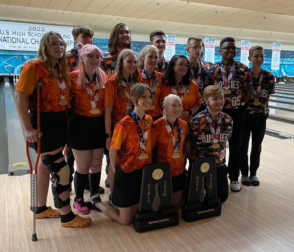 Harlem's girls and boys bowling teams pose with the two national championship plaques on Saturday, June 18, 2022, in Louisville, Kentucky.