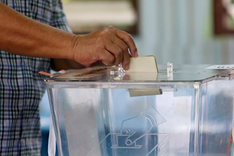 FILE PHOTO: A man casts his vote during the by-election in Port Dickson