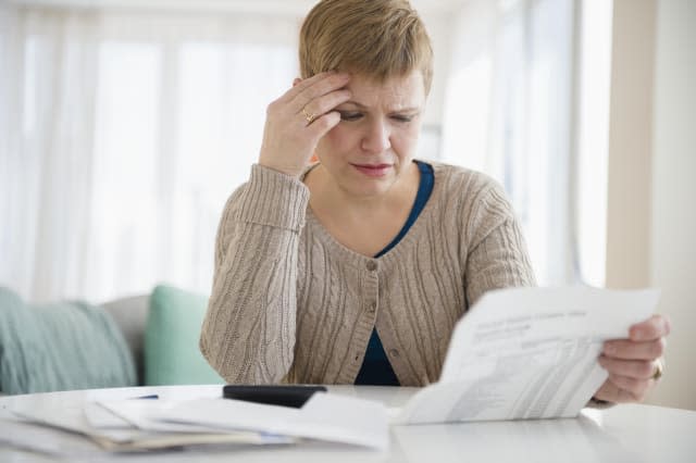 Anxious woman paying bills