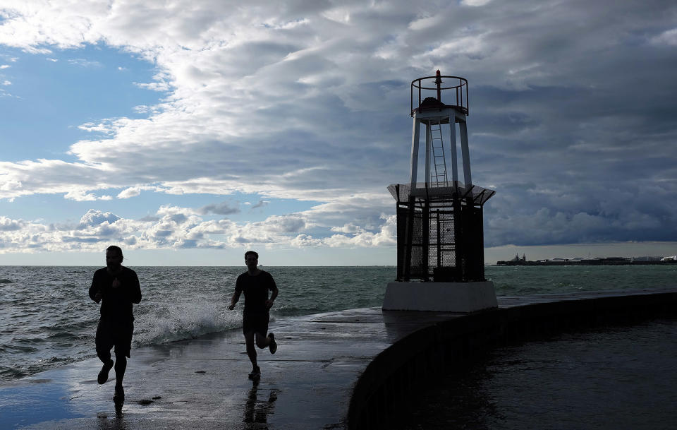 Runners cruise by the lighthouse in Chicago