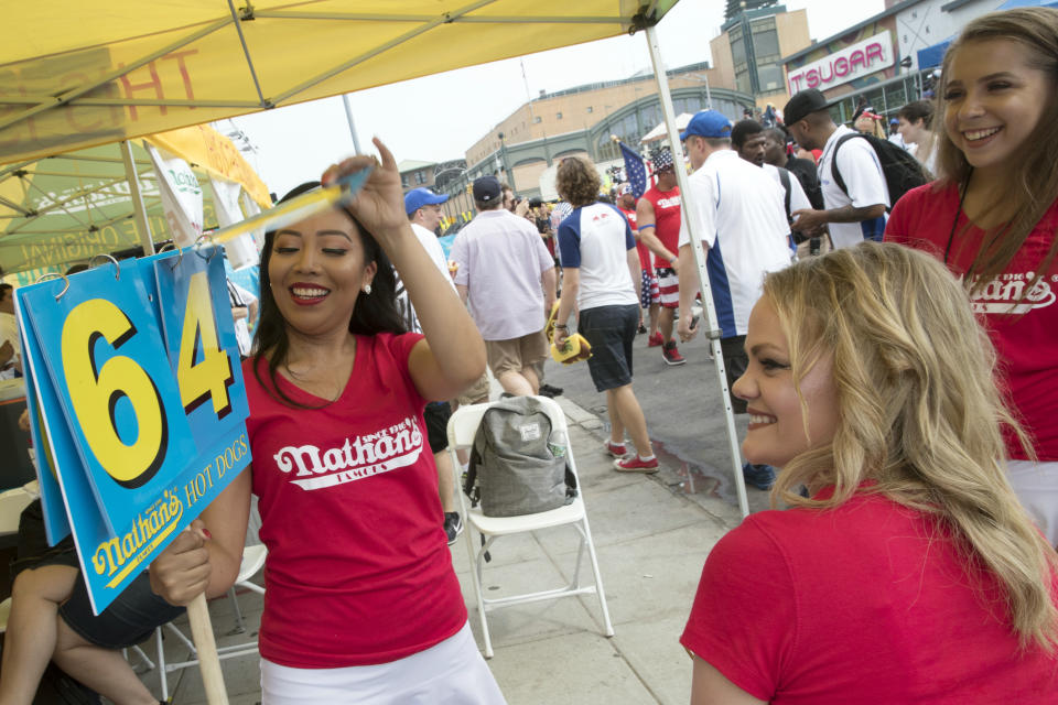<p>The Bunnettes practice the changing the numbers on the score cards ahead of the Famous Fourth of July hot dog eating contest, Wednesday, July 4, 2018, in New York’s Coney Island. (Photo: Mary Altaffer/AP) </p>