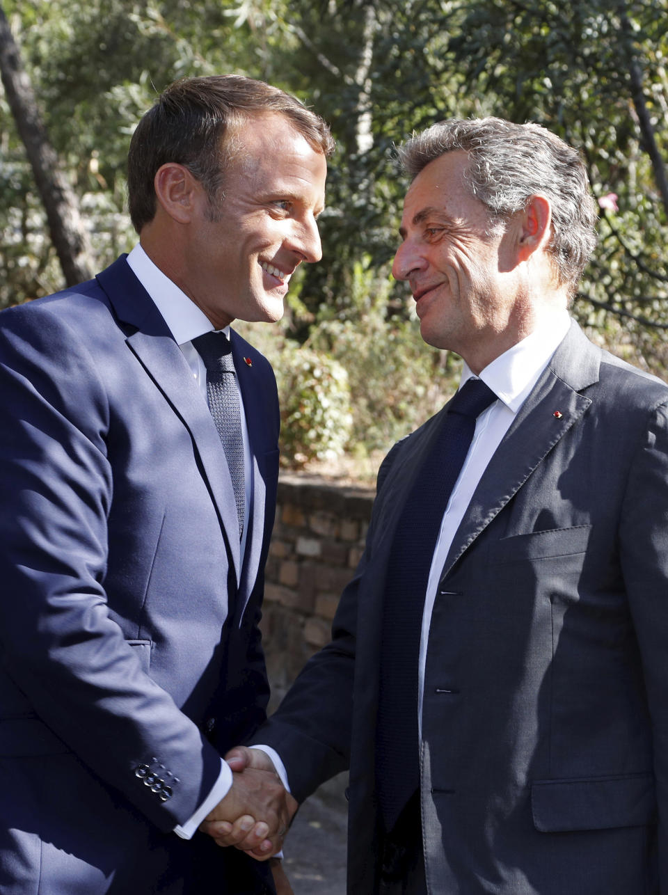 French President Emmanuel Macron, left, meets former French President Nicolas Sarkozy during a ceremony marking the 75th anniversary of the WWII Allied landings in Provence, in Saint-Raphael, southern France, Thursday, Aug. 15, 2019. Starting on Aug. 15, 1944, French and American troops — 350,000 in total — landed on the French Riviera. U.S. forces drove north while French troops — many from French colonies in Africa — moved along the coast to secure key ports. (Eric Gaillard/POOL via AP)