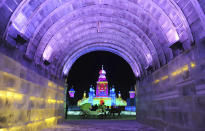 A horse carriage carrying tourists travels past ice sculptures during the lights testing period of the 13th Harbin Ice and Snow World in Harbin, Heilongjiang province December 25, 2011. The Harbin International Ice and Snow Festival will be officially launched on January 5, 2012. Picture taken December 25, 2011. REUTERS/Sheng Li (CHINA - Tags: ENVIRONMENT SOCIETY TRAVEL)