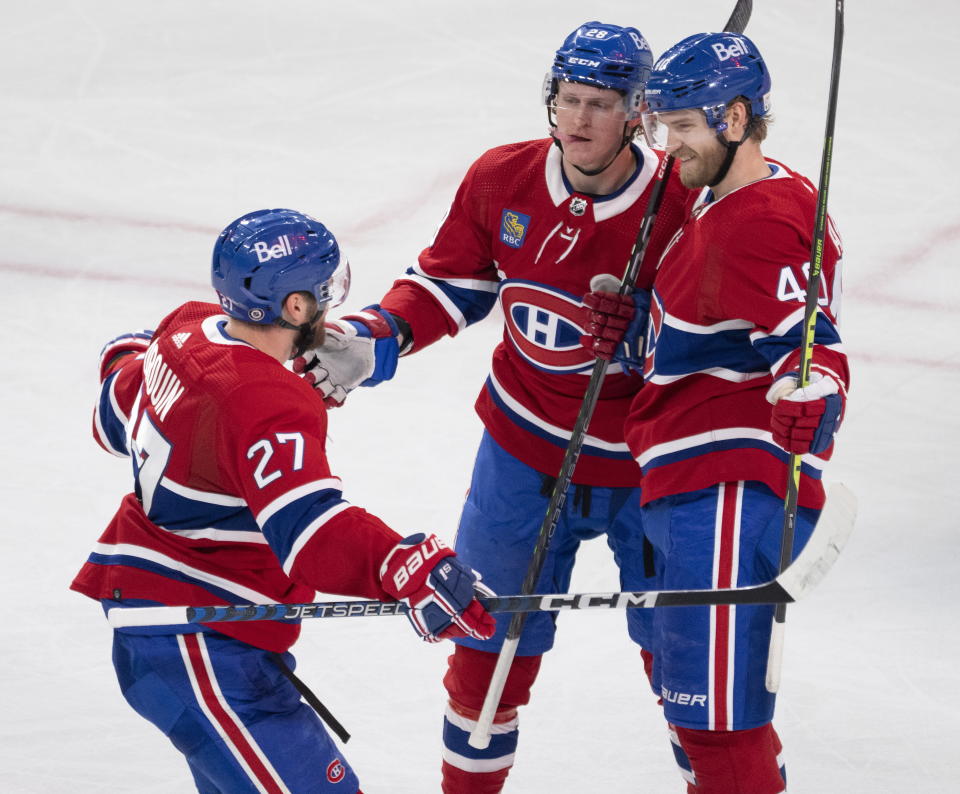 Montreal Canadiens right wing Joel Armia (40) celebrates with teammates Christian Dvorak (28) and Jonathan Drouin (27) after scoring during the third period of an NHL hockey game against the Chicago Blackhawks, Tuesday, Feb.14, 2023 in Montreal. (Ryan Remiorz/The Canadian Press via AP)