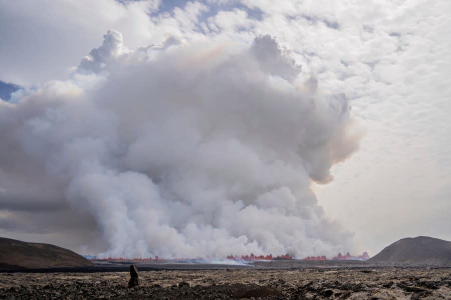 A cloud of smoke billows as a volcano erupts in Grindavik, Iceland, Wednesday, May 29, 2024. A volcano in southwestern Iceland is erupting, spewing red streams of lava in its latest display of nature’s power. A series of earthquakes before the eruption Wednesday triggered the evacuation of the popular Blue Lagoon geothermal spa. The eruption began in the early afternoon north of Grindavik, a coastal town of 3,800 people that was also evacuated. (AP Photo/Marco di Marco)