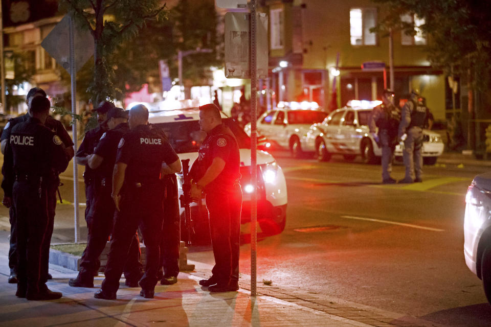 <p>Toronto Police officers walk the scene at Danforth St. at the scene of a shooting in Toronto, Ontario, Canada on July 23, 2018. (Photo: Cole Burston/AFP) </p>