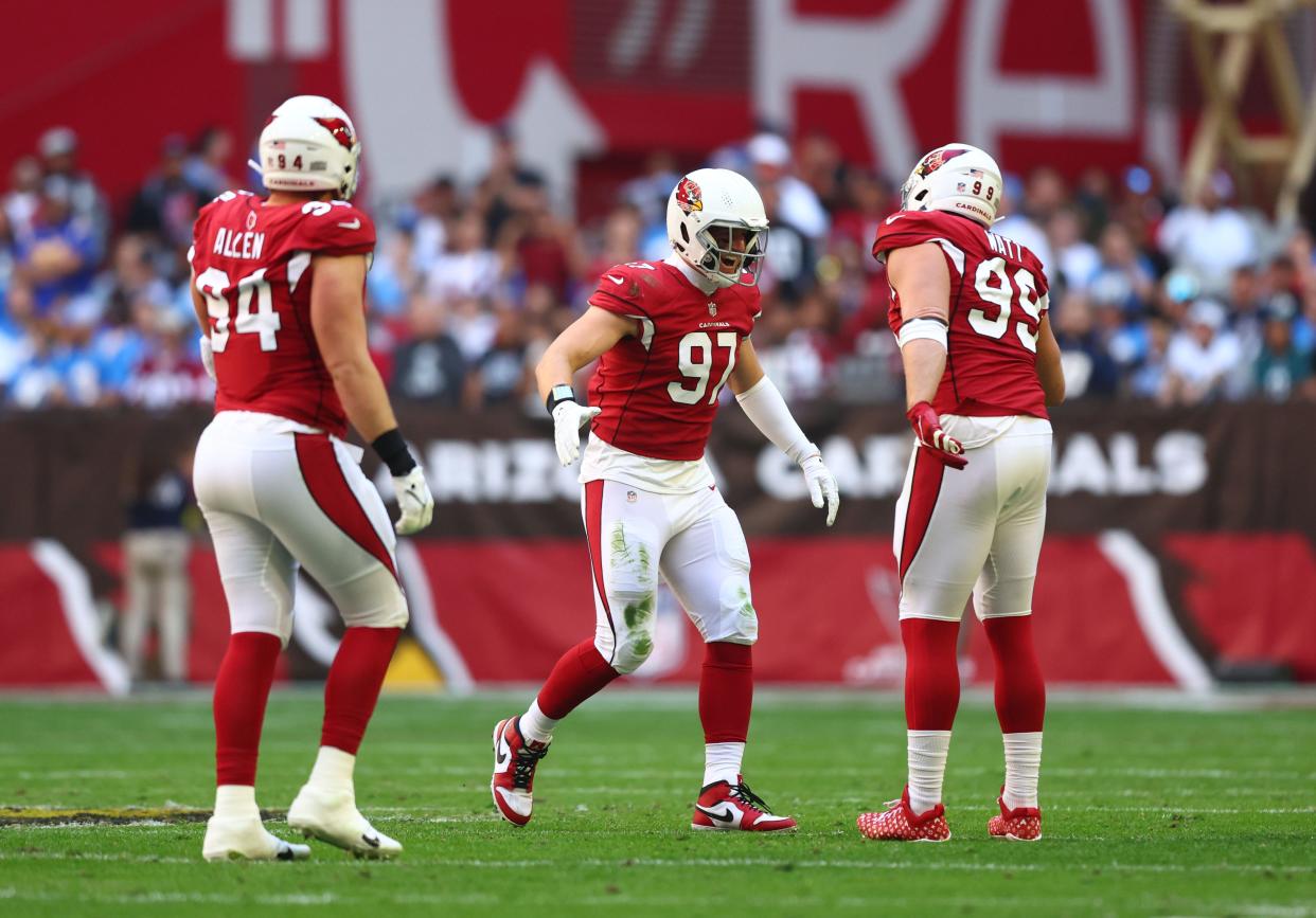 Nov 27, 2022; Glendale, Arizona, USA;  Arizona Cardinals linebacker Cameron Thomas (97) celebrates with defensive end J.J. Watt (99) after a sack against the Los Angeles Chargers in the first half at State Farm Stadium.