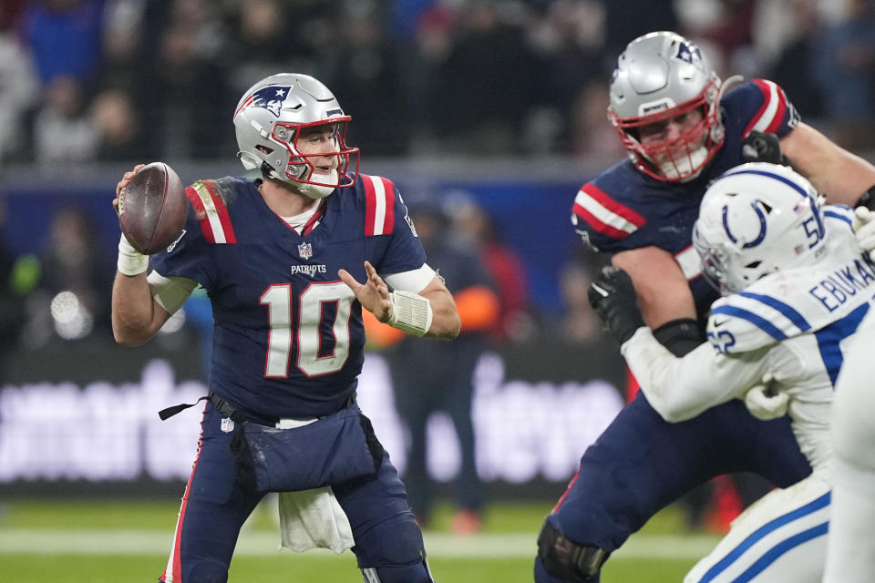 New England Patriots quarterback Mac Jones (10) drops back to pass under pressure from Indianapolis Colts defensive end Samson Ebukam (52) in the second half of an NFL football game in Frankfurt, Germany Sunday, Nov. 12, 2023. (AP Photo/Martin Meissner)
