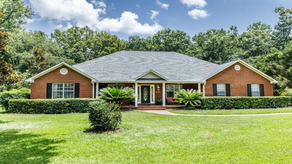 An exterior of a house with lawn