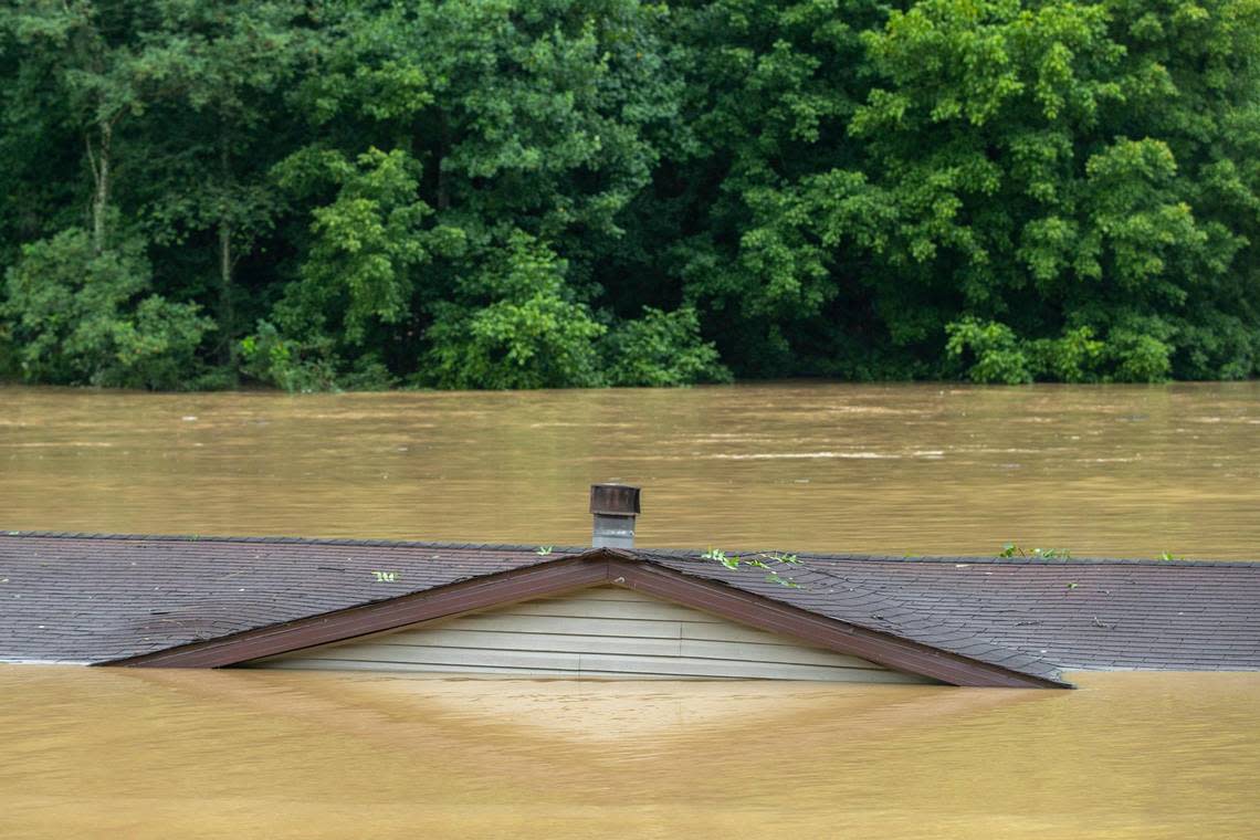 A home floats in the North Fork of the Kentucky River near Lost Creek, Ky., on Thursday, July 28, 2022. (Ryan C. Hermens/Lexington Herald-Leader via AP)