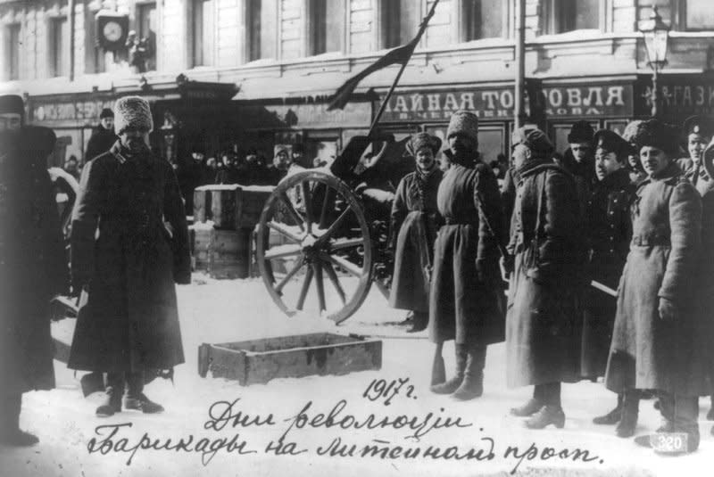 People stand in front of a barricade on Liteinyi avenue in St. Petersburg in October of 1917. On March 8, 1917, strikes and riots in St. Petersburg marked the start of the Russian Bolshevik revolution. File Photo courtesy of the Library of Congress