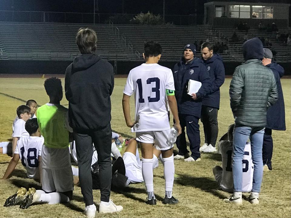 Casteel head coach Greg Lanman goes over instructions with his team at halftime against Verrado on Tuesday, Jan. 18, 2022, at Verrado High School.