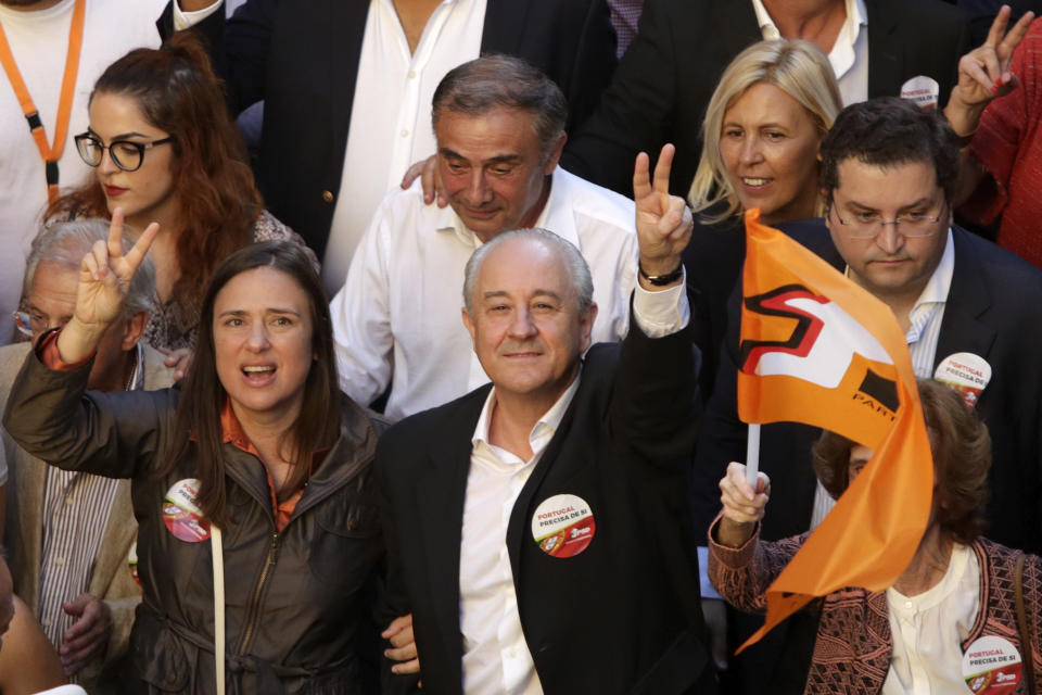Rui Rio, leader of the Social Democratic Party, and councilwoman Filipa Roseta gesture during an election campaign action in downtown Lisbon Friday, Oct. 4, 2019. Portugal will hold a general election on Oct. 6 in which voters will choose members of the next Portuguese parliament. (AP Photo/Armando Franca)