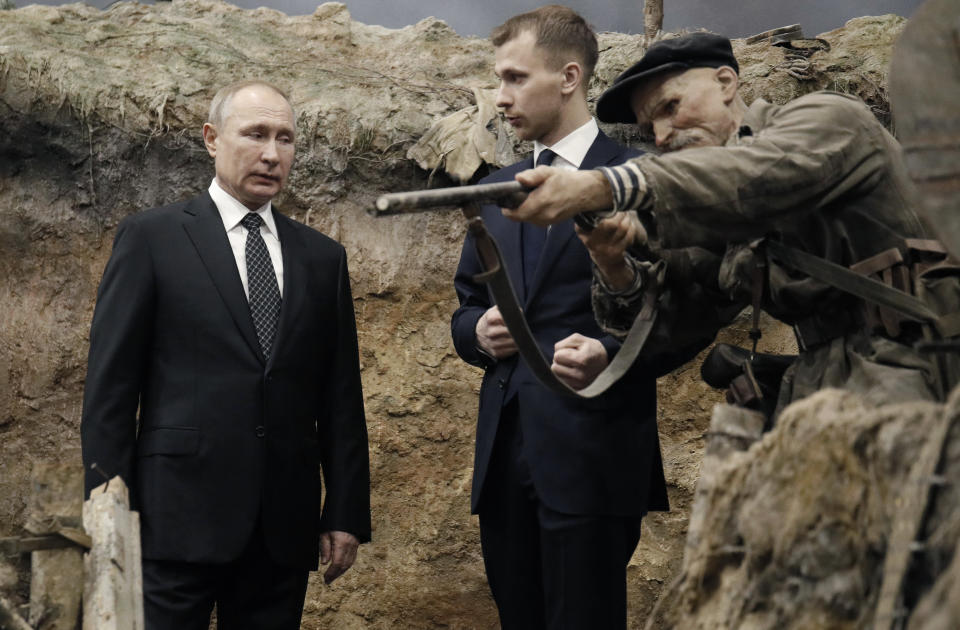 Russian President Vladimir Putin, left, visits the exhibition - 'Memory speaks. The road through the war' in St. Petersburg, Russia, Saturday, Jan. 18, 2020. Putin will atten events marking the 77th anniversary of the break of Nazi's siege of Leningrad. The Red Army broke the nearly 900-day blockade of the city on January 19, 1943 after fierce fighting. (AP Photo/Dmitri Lovetsky, Pool)