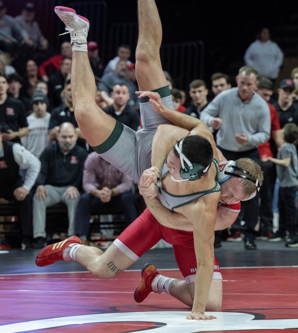 Rutgers' Jackson Turley (red singlet), recorded a 7-2 win at 174 pounds over Michigan State's Caesar Garza Friday night in the Scarlet Knights' 16-15 win over the Spartans.