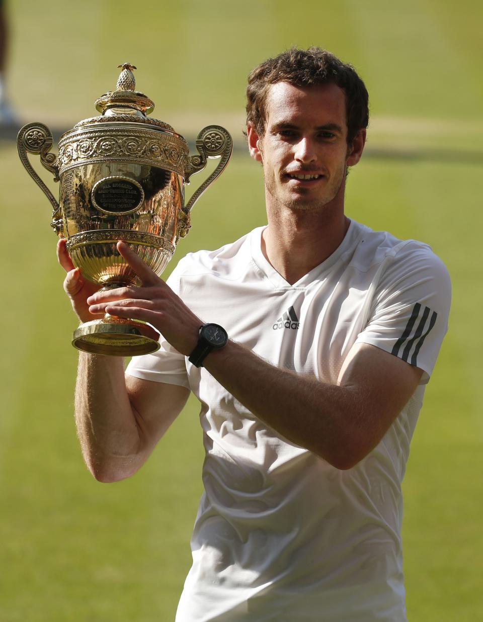 Great Britain's Andy Murray celebrates with the trophy after defeating Serbia's Novak Djokovic in the Men's Final during day thirteen of the Wimbledon Championships at The All England Lawn Tennis and Croquet Club, Wimbledon.