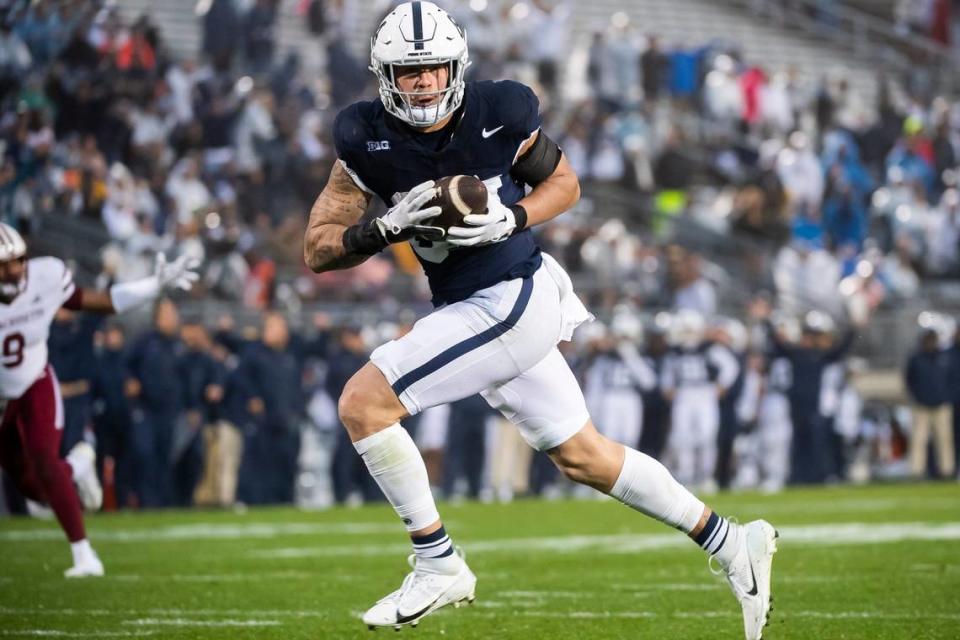 Penn State tight end Theo Johnson (84) goes 30 yards to score a touchdown during the second half of a NCAA football game against Massachusetts Saturday, Oct. 14, 2023, in State College, Pa. The Nittany Lions won, 63-0.