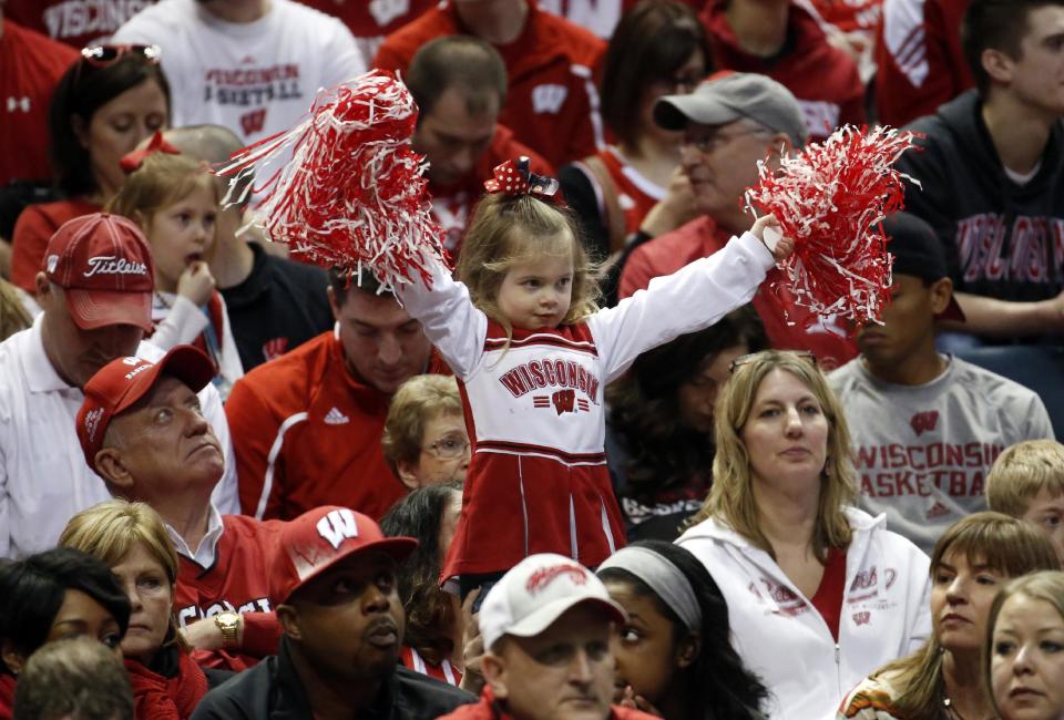 A young Wisconsin fan cheers during the first half of a second-round game between Wisconsin and American in the NCAA college basketball tournament, Thursday, March 20, 2014, in Milwaukee. (AP Photo/Jeffrey Phelps)