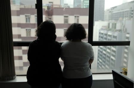 Sisters from Saudi Arabia, who go by aliases Reem and Rawan, are pictured at their lawyer Michael Vidler's office in Hong Kong, China February 23, 2019. REUTERS/Aleksander Solum