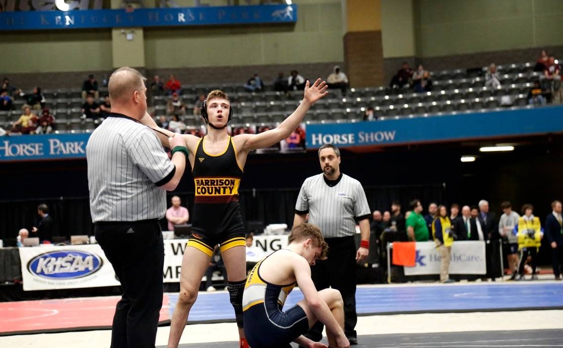 Harrison County’s George Dennis lets out a sigh as he celebrates his win in the 120 finals over Grant County’s Ethan Davis at the boys/coed KHSAA State Wrestling Championships at the Kentucky Horse Park’s Alltech Arena on Friday.