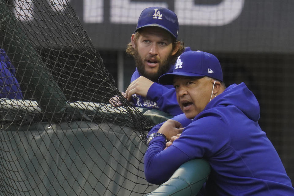 Los Angeles Dodgers manager Dave Roberts and starting pitcher Clayton Kershaw watch batting practice before Game 2 of the baseball World Series against the Tampa Bay Rays Wednesday, Oct. 21, 2020, in Arlington, Texas. (AP Photo/Sue Ogrocki)