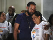 Miya Marcano's family, her father Marlon Marcano, center left, hosts a candlelight vigil at Arden Villas, Friday, Oct. 1, 2021, in Orlando, Fla. Orange County Sheriff John Mina said Saturday that authorities found Miya Marcano’s body near an apartment building. Marcano vanished on the same day a maintenance man improperly used a master key to enter her apartment. (Chasity Maynard/Orlando Sentinel via AP)