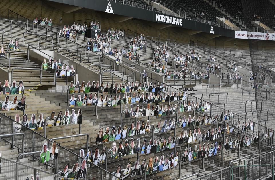 FILE - In this Thursday, April 16, 2020 file photo, portraits of fans of German Bundesliga soccer club Borussia Moenchengladbach are set on the supporters tribune in the stadium in Moenchengladbach, Germany. The coronavirus pandemic has changed almost everything about soccer in Germany, except Bayern Munich's chances of winning. When the Bundesliga resumes on Saturday, May 16 after a two-month suspension caused by the pandemic, Borussia Dortmund and Leipzig will be Bayern's main challengers.(AP Photo/Martin Meissner, file)