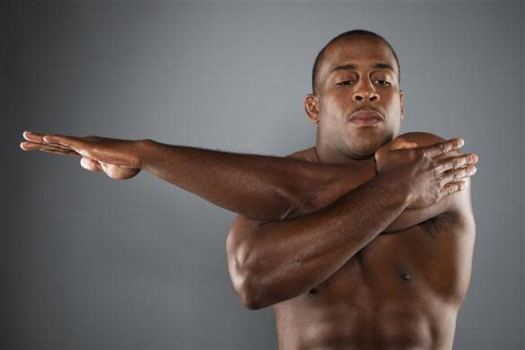 Greco-Roman wrestler Justin Lester stretches while posing for a portrait during the 2012 U.S. Olympic Team Media Summit in Dallas, May 15, 2012.