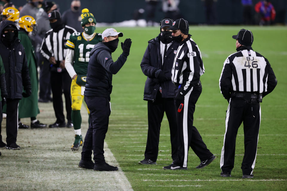 Head coach Matt LaFleur of the Green Bay Packers speaks to the referees