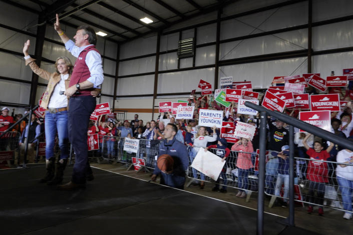 Republican gubernatorial candidate Glenn Youngkin and his wife Suzanne, wave to supporters during a rally in Chesterfield, Va., Monday, Nov. 1, 2021. Youngkin will face Democrat former Gov. Terry McAuliffe in the November election. (AP Photo/Steve Helber)