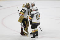 Vegas Golden Knights goalie Marc-Andre Fleury (29) celebrates with Chandler Stephenson (20) and Jonathan Marchessault (81) after the team's 5-2 win over the Minnesota Wild in Game 3 of a first-round NHL hockey playoff series Thursday, May 20, 2021, in St. Paul, Minn. (AP Photo/Stacy Bengs)