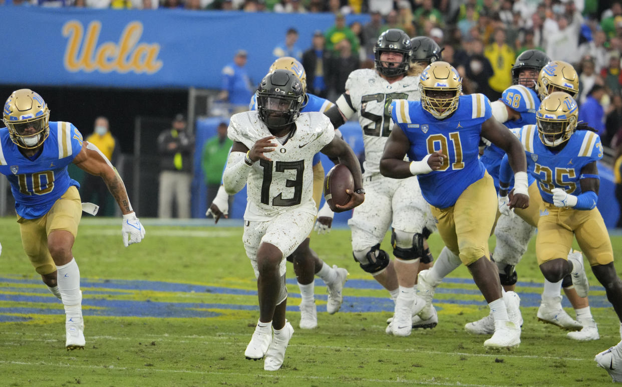 Pasadena, CA - October 23:  Quarterback Anthony Brown #13 of the Oregon Ducks runs for a touchdown against the UCLA Bruins in the fourth quarter as the Oregon Ducks defeated the UCLA Bruins 34-31 during a NCAA Football game at the Rose Bowl in Pasadena on Saturday, October 23, 2021. (Photo by Keith Birmingham/MediaNews Group/Pasadena Star-News via Getty Images)