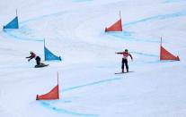 Snowboard - Pyeongchang 2018 Winter Olympics - Men's Parallel Giant Slalom Finals - Phoenix Snow Park - Pyeongchang, South Korea - February 24, 2018 - Nevin Galmarini of Switzerland and Lee Sang-ho of South Korea compete. REUTERS/Mike Blake