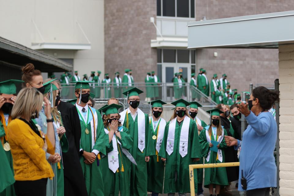 Farmington High School graduates wait to enter Hutchison Stadium before the commencement ceremony on May 18, 2021.
