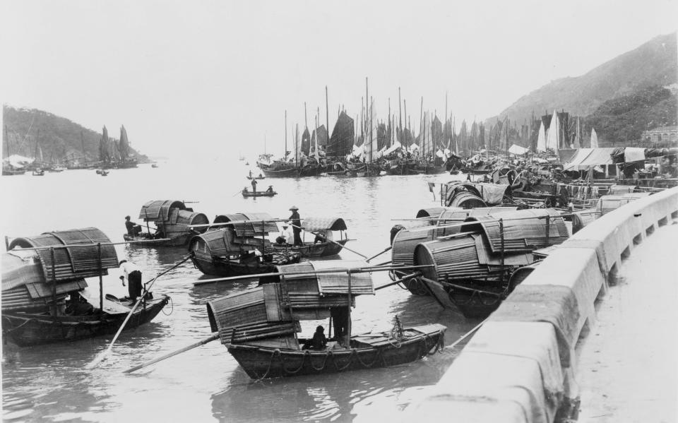 Sampans floating near the shore in Hong Kong.