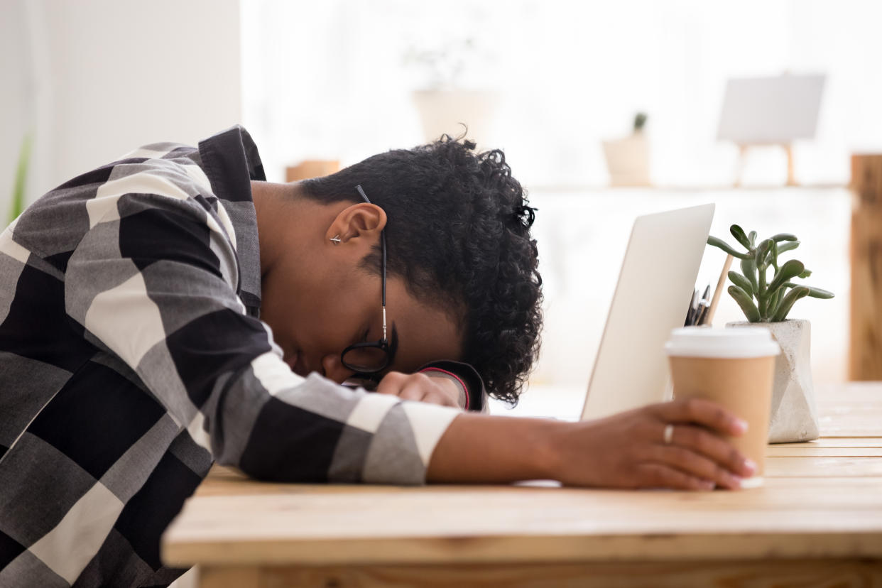 Woman tired at desk after not having enough sleep. (Getty Images)